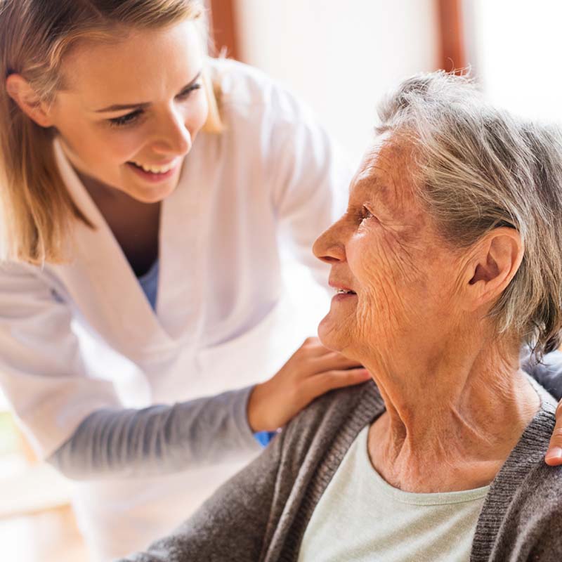 image of a nurse caring for an elderly woman